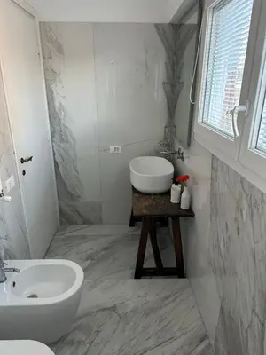a white bathroom with a sink and a tub and a sink at Home34 in Rome
