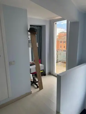 a room with a ladder and a room with a window at Home34 in Rome