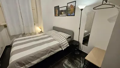 a small bedroom with a bed and a lamp at DidiHouse in Rome