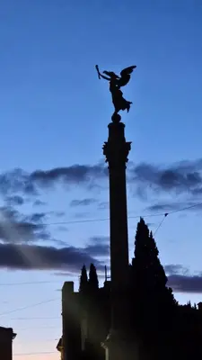 a silhouette of a statue on top of a building at DidiHouse in Rome