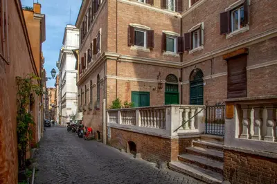 an alley with a building with a balcony on it at Emperor's View in Colosseum in Rome