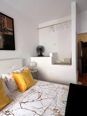 a bedroom with a bed with yellow pillows on it at Shalimar Navona in Rome