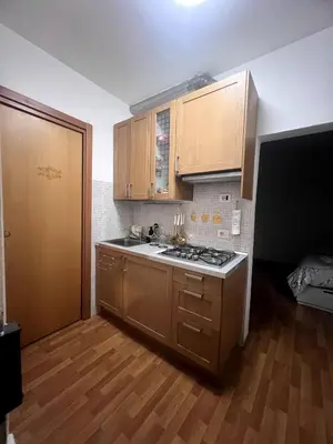 a kitchen with wooden cabinets and a stove top oven at Shalimar Navona in Rome