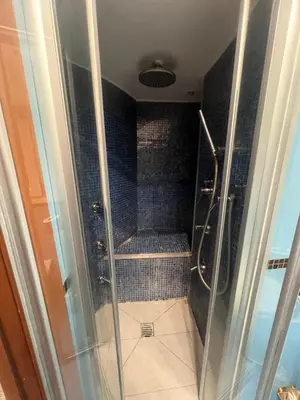 a bathroom with a walk in shower with a glass door at Shalimar Navona in Rome