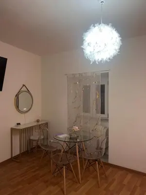 a dining room with a glass table and a chandelier at Shalimar Navona in Rome