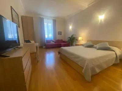 a bedroom with a bed and a flat screen tv at La Pianista sull'oceano in Rome