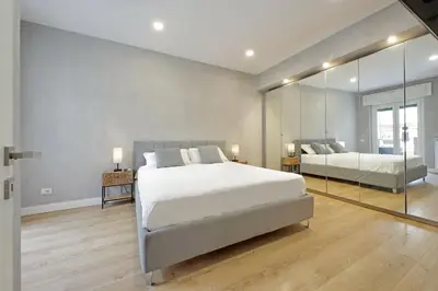 a bedroom with two beds and a large mirror at A casa in Rome
