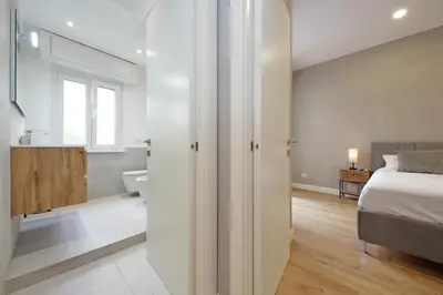 a bedroom with a bed and a bathroom at A casa in Rome
