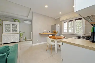 a kitchen and dining room with a table and chairs at A casa in Rome