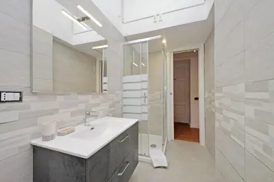 a bathroom with a sink and a mirror at A casa, Aventino in Rome