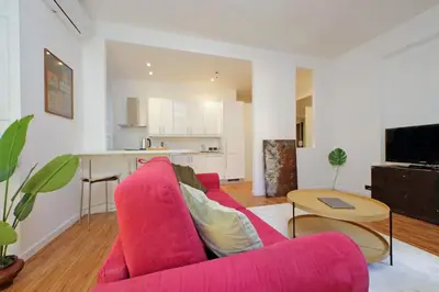 a living room with a red couch and a table at A casa, Aventino in Rome