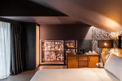 a hotel room with a bed and a desk at The Goethe Hotel - Small Luxury Hotels of the World in Rome