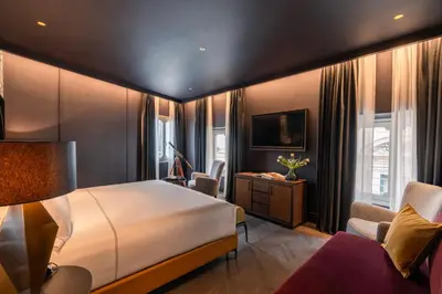 a hotel room with a bed and a desk at The Goethe Hotel - Small Luxury Hotels of the World in Rome