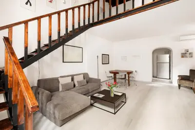 a living room with a couch and a table at Navona Charming Apartment by Romeloft in Rome
