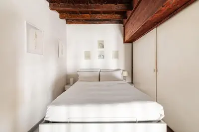 a bedroom with a bed in a white room at Navona Charming Apartment by Romeloft in Rome