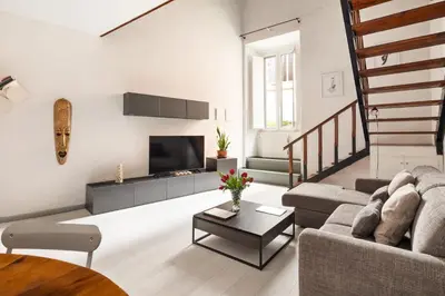 a living room with a couch and a tv at Navona Charming Apartment by Romeloft in Rome