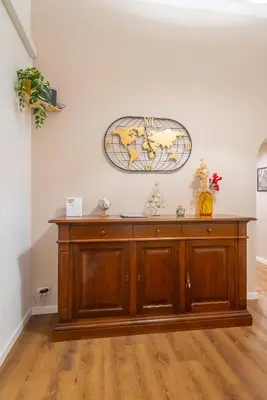 a large wooden cabinet in a room at Flower Fields Home - Appartamento Campo dei Fiori in Rome