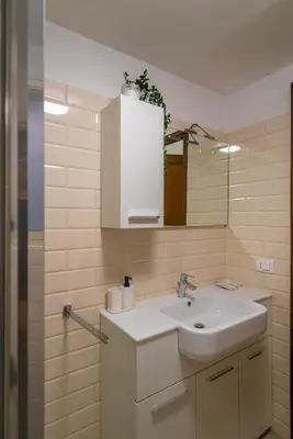 a bathroom with a sink and a mirror at Flower Fields Home - Appartamento Campo dei Fiori in Rome