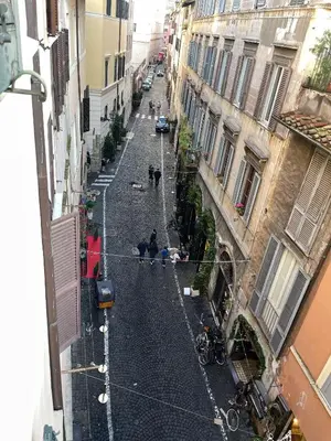 an empty street in an alley between two buildings at Flower Fields Home - Appartamento Campo dei Fiori in Rome