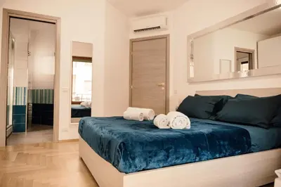 a bedroom with a large bed with towels on it at Dea Suites Two in Rome