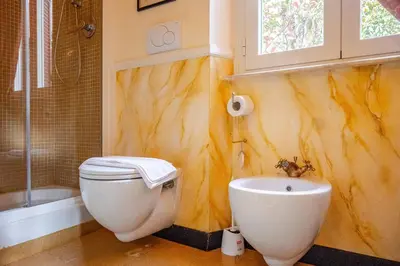 a bathroom with a toilet and a sink at Parcheggio Privato - Villa Liberty Roma Centro in Rome