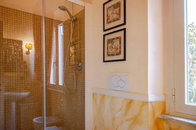a bathroom with a shower and a glass shower stall at Parcheggio Privato - Villa Liberty Roma Centro in Rome
