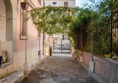 an alley in a city with an archway at Parcheggio Privato - Villa Liberty Roma Centro in Rome