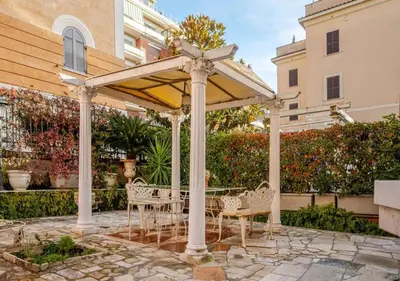 a gazebo with a table and chairs under it at Parcheggio Privato - Villa Liberty Roma Centro in Rome