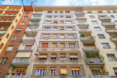 a tall apartment building with windows and balconies at DOMUS LUX ANGELICA- Nearby Vatican in Rome