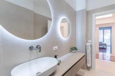 a bathroom with a white sink and a mirror at DOMUS LUX ANGELICA- Nearby Vatican in Rome