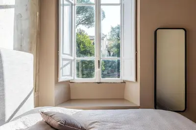 a bedroom with a bed in front of a window at GuestHost - Central and Modern apartment in Rione Monti in Rome