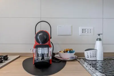 a red blender sitting on a counter in a kitchen at Green House Marconi in Rome