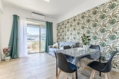 a living room with a table and a couch at Green House Marconi in Rome