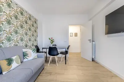 a living room with a couch and a table at Green House Marconi in Rome