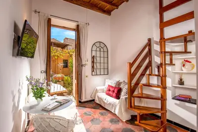 a living room with a staircase and a couch at Empire Loft in the shadow of Colosseum in Rome