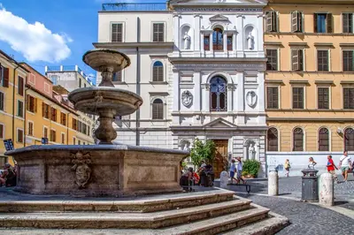 a fountain in front of a building in a city at Empire Loft in the shadow of Colosseum in Rome