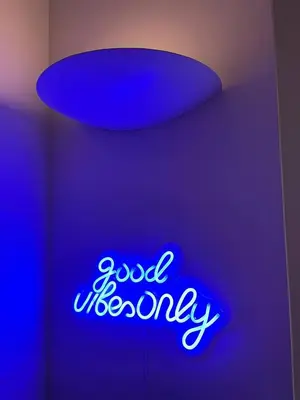a neon sign that says good welcome on a ceiling at Easylife - Vatican Terrace Apartment in Rome