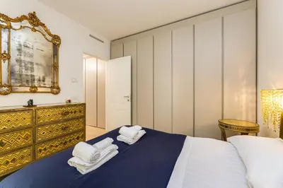 a bedroom with a bed with towels on it at Easylife - Vatican Terrace Apartment in Rome