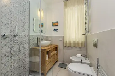 a bathroom with a toilet and a sink and a shower at Easylife - Vatican Terrace Apartment in Rome