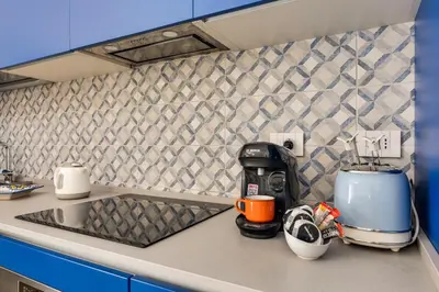 a kitchen counter with a coffee maker on a counter top at Easylife - Vatican Terrace Apartment in Rome