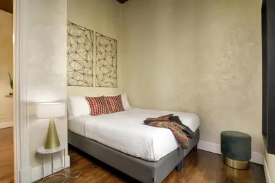 a small bedroom with a bed and a lamp at Spanish Steps Boutique Apartment in Rome