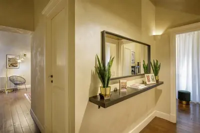 a hallway with a mirror and plants on a wall at Spanish Steps Boutique Apartment in Rome