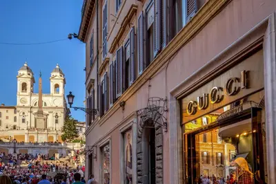 a crowd of people walking down a street with buildings at Spanish Steps Boutique Apartment in Rome