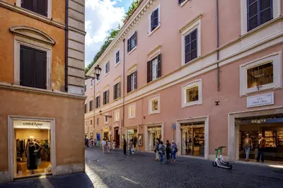 a group of people walking down a street with buildings at Spanish Steps Boutique Apartment in Rome