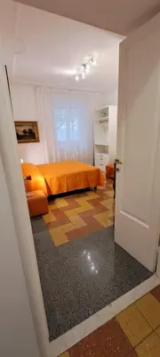 a bedroom with an orange bed in a room at Machiavelli Forty Seven in Rome
