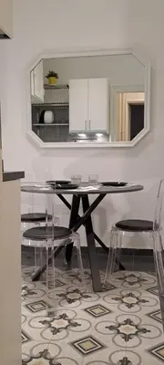 a dining room with a table and chairs and a mirror at Machiavelli Forty Seven in Rome