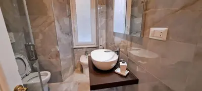 a bathroom with a sink and a toilet and a mirror at Machiavelli Forty Seven in Rome
