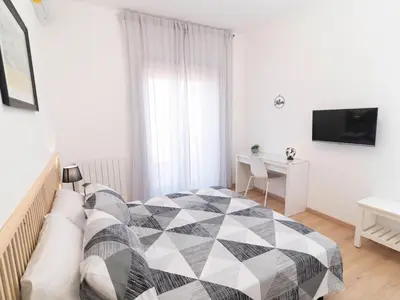 a bedroom with a bed and a desk and a television at Alloggio Roma San Pietro da Silvia in Rome