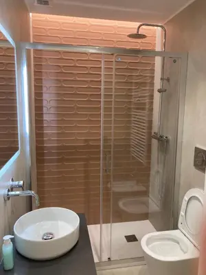 a bathroom with a shower and a sink and a toilet at Manzoni bilocale con doppi servizi piano terra in Rome