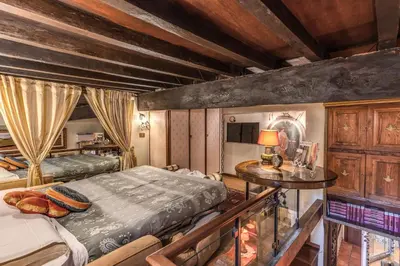 a bedroom with two beds and a table with a lamp at The Eleanor Secret Studio - Campo de' Fiori in Rome